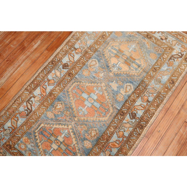 A small size early 20th century Persian Malayer rug in blue and orange Measures: 2'7" x 4'7".