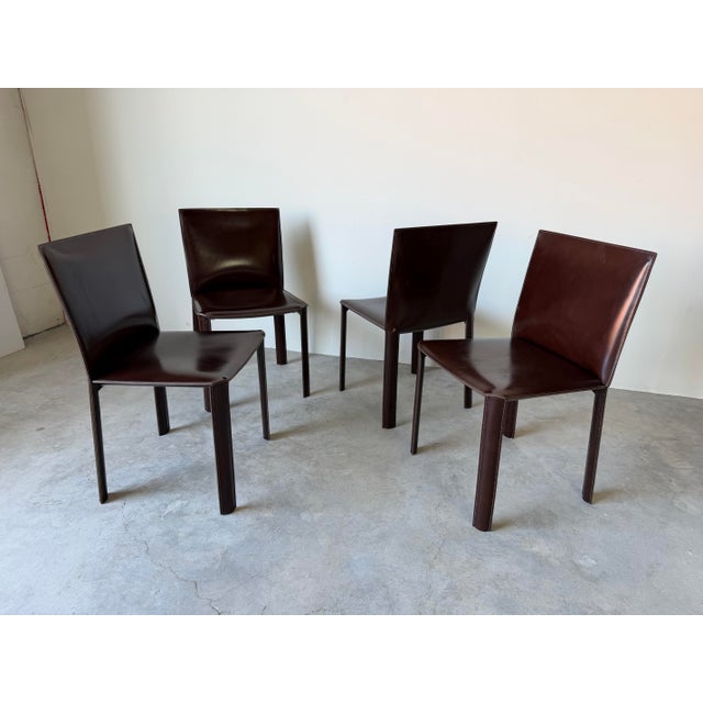 A striking set of four vintage Italian dining chairs crafted in the iconic style of Mario Bellini. These sculptural...
