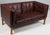 Illum Wikkelsø 1919-1999. Two-seat sofa, freestanding, upholstered in brown leather, loose cushions with down filling, oak...