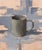 Dark Cup on Grey by Jon Doran | Oil on panel Still life of a dark grey cup on a textured background For Sale