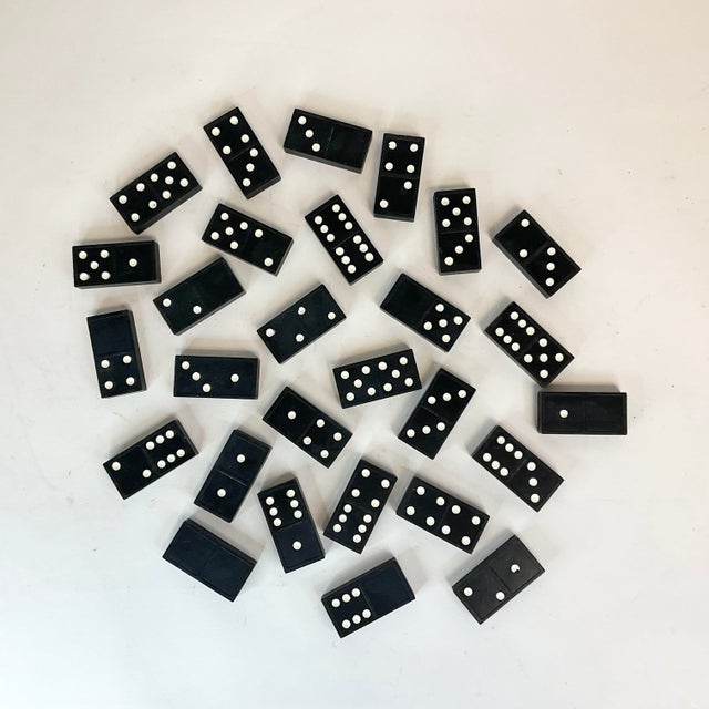 A complete set of vintage Dominos with a nostalgic fun vibe. They are a black resin with white painted dots.