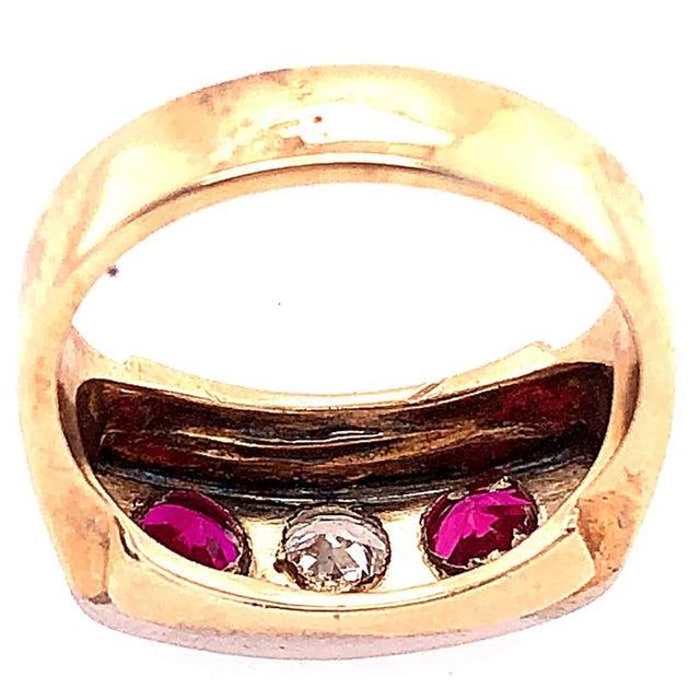 14 Karat Yellow and White Gold Three Stone Diamond and Ruby Band Ring 0.65 total diamond weight. Size 8 8.90 grams total...