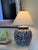 A striking extra-large blue and white porcelain lamp base with an ornate, all-over floral and scrolling vine design. The...