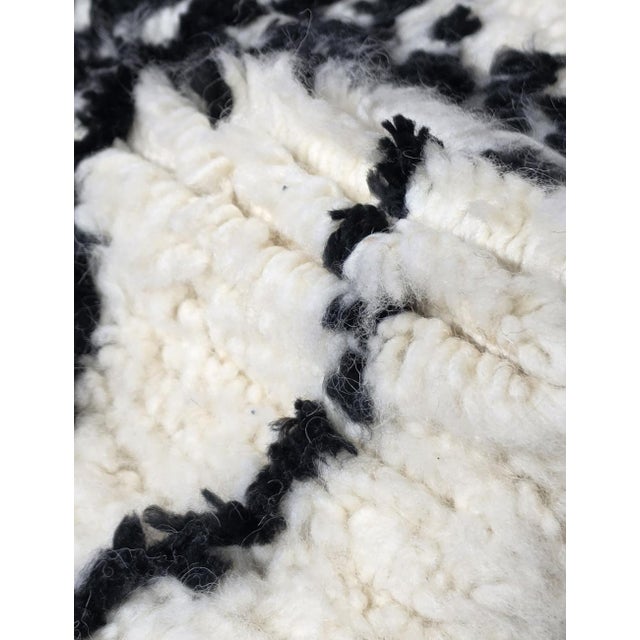 Moroccan Azilal Rug – Handmade Berber Wool Statement Rug This handmade Moroccan Azilal rug features a striking balance of...