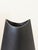 A matte-black ceramic vase from Evangeline Pottery (Labelle, Quebec), from the 1960s–70s. The form is a tapered...