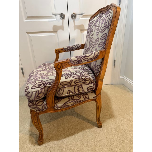 Attractive carved Louis XV-style armchair upholstered in tan linen with plum embroidered floral detail. Usable immediately...