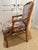 Attractive carved Louis XV-style armchair upholstered in tan linen with plum embroidered floral detail. Usable immediately...