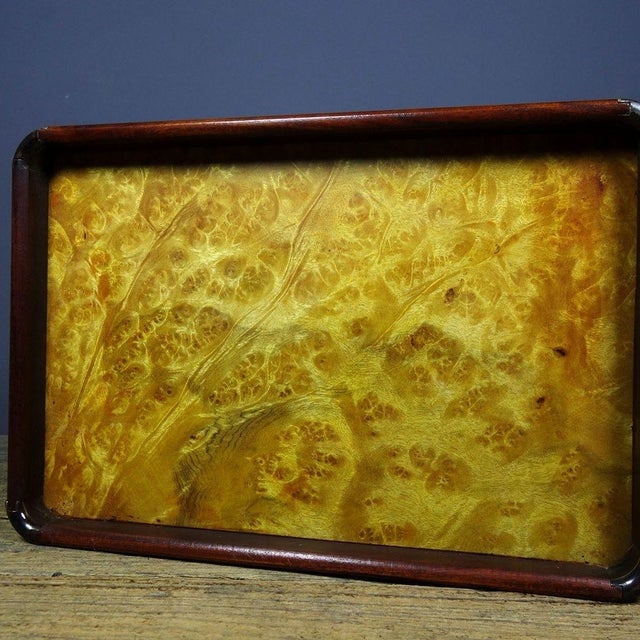 This is an elegant vintage Chinese tea tray, featuring a striking golden burl wood (Nanmu) panel set within a dark...