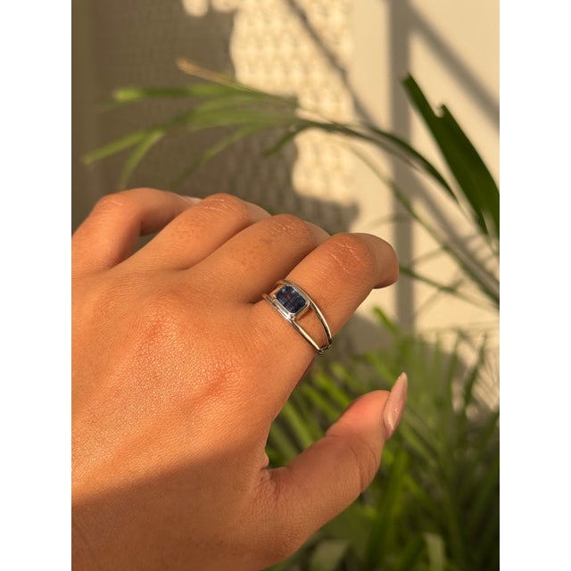 This modernist 1.12-carat octagon deep blue sapphire double-band ring is crafted in 14K white gold. The sapphires measure...
