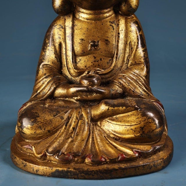 This is a beautifully aged Chinese Buddhist sculpture depicting the historical Buddha seated in full lotus position...