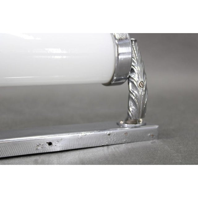 This czechoslovak tubular wall light from the 1930s exemplifies the intersection of bauhaus functionalism and european art...