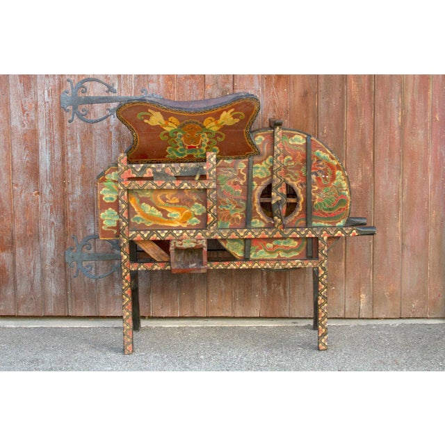 Antique rice separator adorn with beautiful hand painted dragon and floral motifs. Stands on four raised legs with...