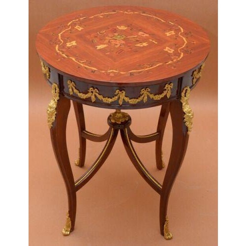 Splendid French Louis XV style marquetry round table, decorated with unique hand made ornate and engraved round bronze, we...