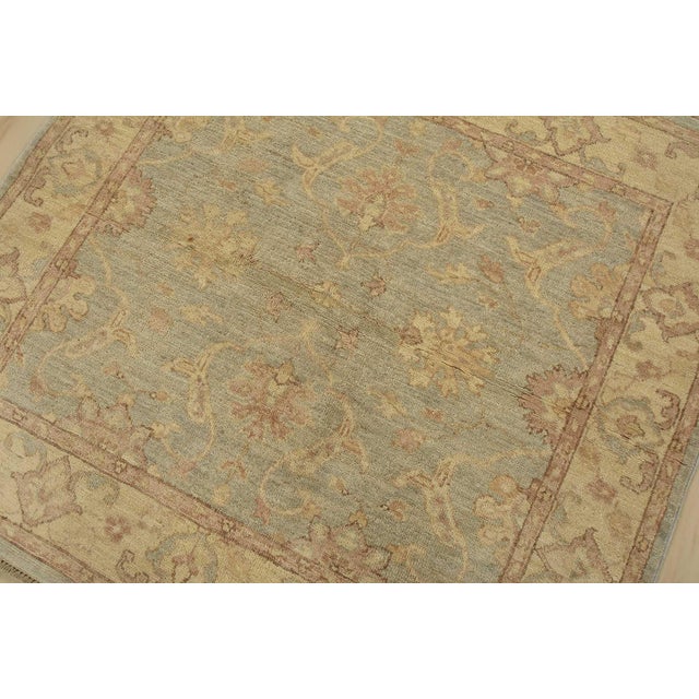 A traditional Ziegler rug hand-knotted with fine wool on a cotton foundation. This rug features a botanical design set...