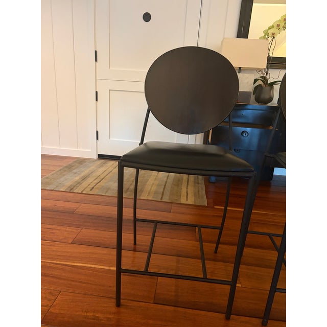Memphis-style "Vik-Ter" black maple and leather counter stools by Dakota Jackson. The stools comes with a curved circular...