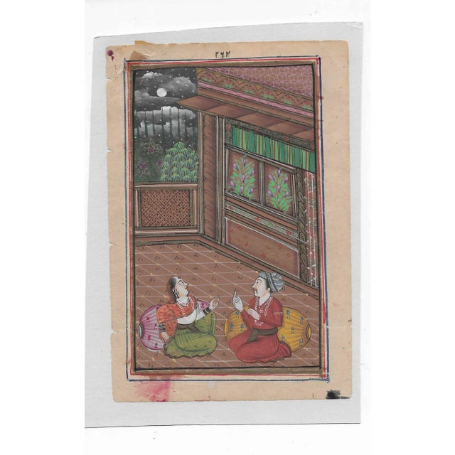 Antique Bundi painting of an Indian figures in a courtyard. The painting is gouache on paper laid to card with a painted...
