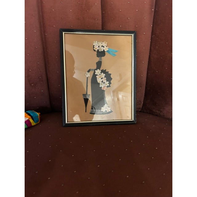 Beautiful gilded age piece shows a woman walking down a sidewalk while carrying her umbrella. A black silhouette paired...