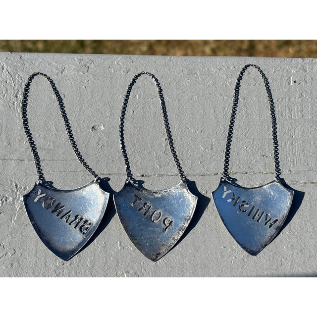 Whiskey, Port, and Brandy. A trio of Late 19th. c. Sterling Silver Liguor / Wine Decanter Plaques. Shield Shaped with...