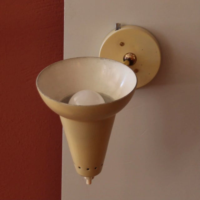 A very rare, unusual wall lamp made of solid brass. The shade can be adjusted very variably thanks to the ball joint. The...