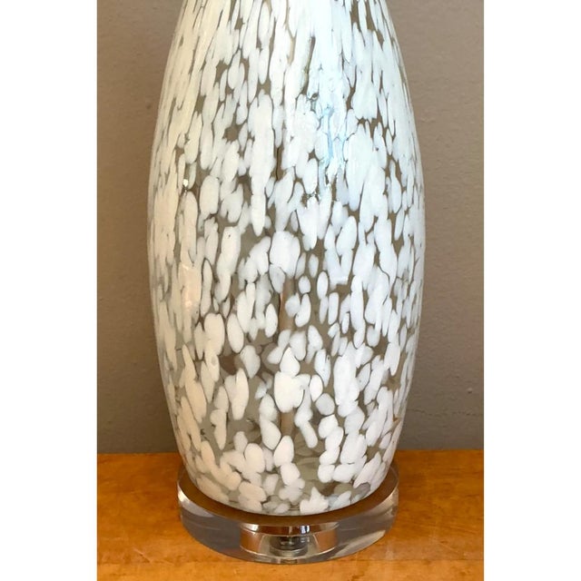 Crafted in hand-blown Art Glass, this striking mid-century table lamp features an elongated amphora-style silhouette with...