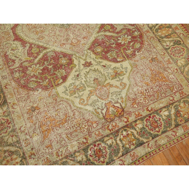 An early 20th Century traditional hand-knotted wool turkish rug with a peculiar irregular angular formal design. This...