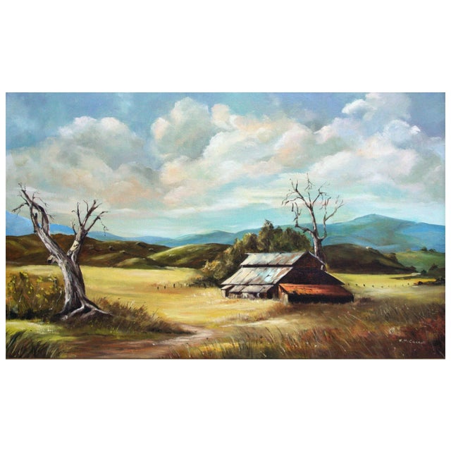Wonderful iconic vintage gold country landscape of wood barn with golden grasslands surrounded by blue mountains by N....