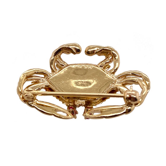 A fun 14K gold brooch in the form of a crab. The eyes are prong set rubies. The body of the crab has a Florentine finish,...