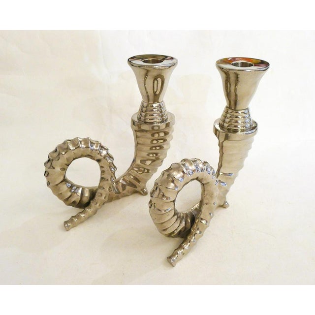 Pair of simple candlesticks/candle holders in the shape of ram or mouflon horns. Naturalistic representation of the horn,...