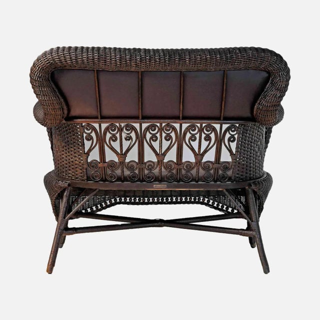 Antique, early 20th century Heywood Wakefield wicker loveseat. Leather seat and backrest. Classic American Victorian style.