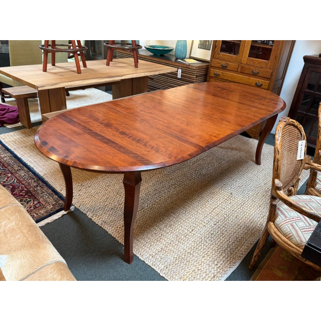 Design Plus Gallery presents a Traditional Queen Anne-Style Oval Extension Dining Table. It has a banded wood top and...