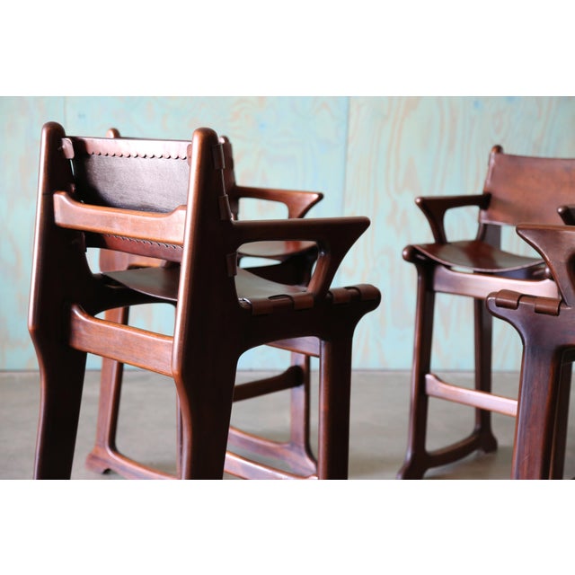 A stunning set of 4 barstools after Sergio Rodrigues and Angel Pazmino. Beautiful solid rosewood frames with interesting...