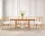 A rare mid-century modern drop-leaf expanding "Danbury" bleached mahogany dining table designed by Tommi Parzinger...