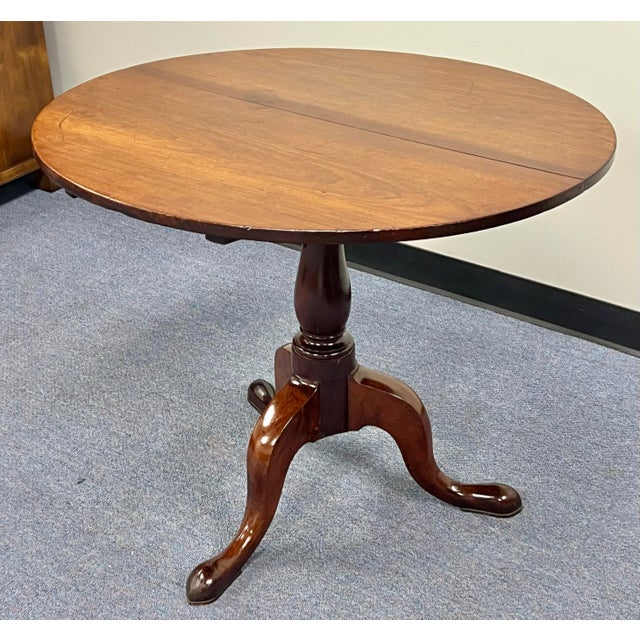18th century circa 1760 Queen Anne mahogany tilt top tea table. Round two board top. Baluster turned tripod base with...
