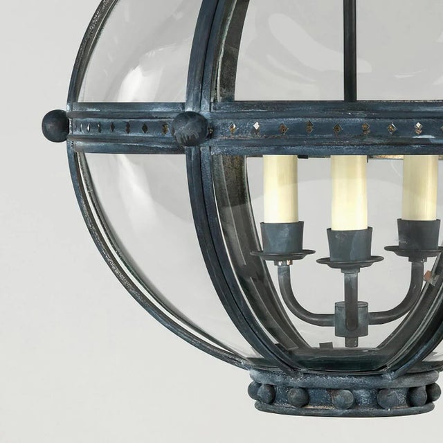 The globe shape of the fixture emanates strength and is united by the solid zinc finish finials and acanthus top. The...