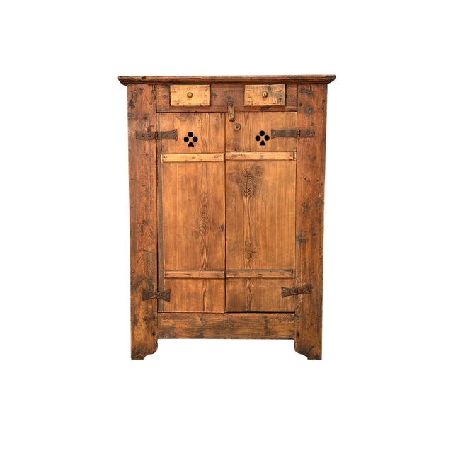 Antique larch cabinet dating back to the 19th century, featuring two doors and two drawers. The doors are ventilated,...