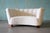 A 1940s Danish channel tufted banana sofa. Chunky curved mahogany legs mimics the shape of the sofa supporting a curvy...