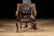 Antique leather and oak chair with tufted upholstery. This piece features a carved oak frame with scrolled armrests. The...