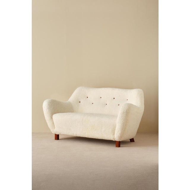 Reupholstered in white sheepskin from Skandilock. Produced by Sten Wicéns Möbelfabrik, Sweden, 1950s. This piece is...