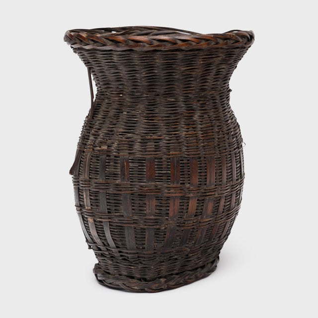 Woven with precious scale and delicate artistry, this petite bamboo basket from the early 20th century is a beautiful...