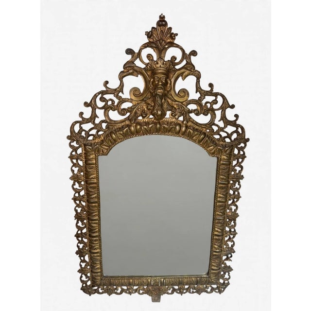 19th century antique Napoleon III style wall mirror featuring embossed bronze or brass workmanship and a crowned head on...