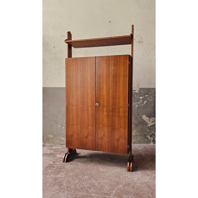Scandinavian-style teak wardrobe/bookcase made in Italy. Large compartment with doors, divided into shelves and a coat...