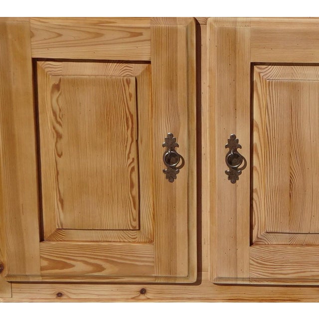 Three-door, three-drawer sideboard made entirely of solid pine. This sideboard features clean, straight lines and a...