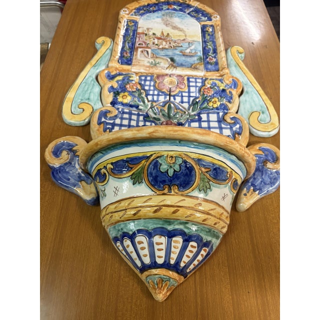 A hand-painted ceramic wall fountain or plate, harking back to the artisanal tradition of Campanian or Vietri ceramics,...