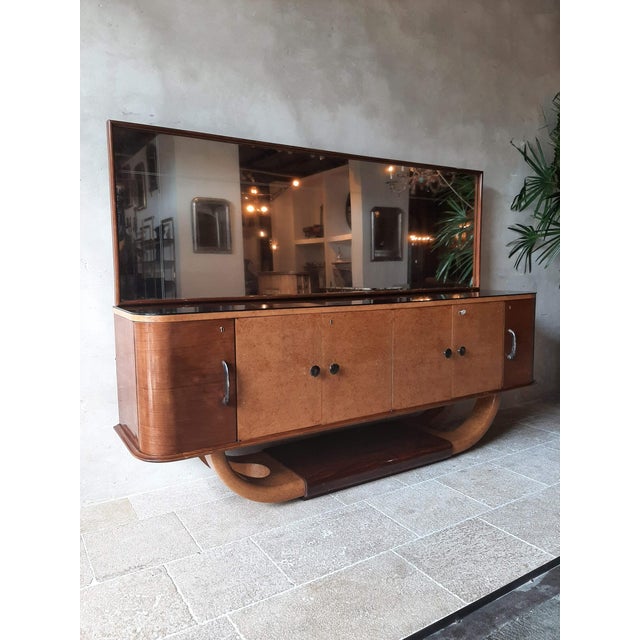 Italian mid-century sideboard with mirror attributed to Osvaldo Borsani from the 1940s. This large 250 cm wide cabinet is...