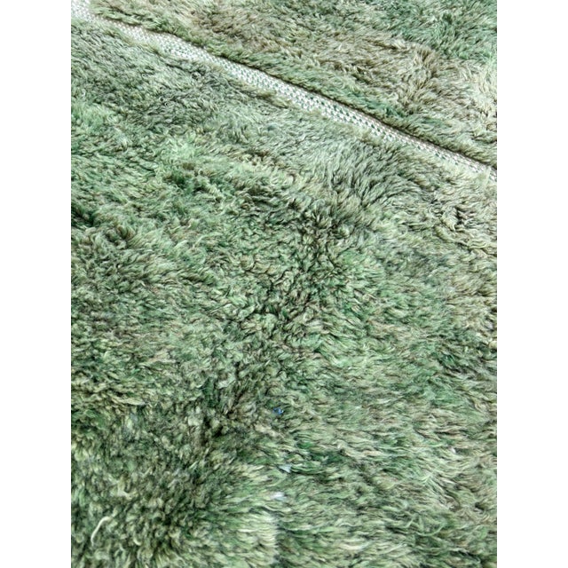 This green rug is a Moroccan handmade rug, made between the middle Atlas and the Atlantic ocean of Morocco. Women in that...