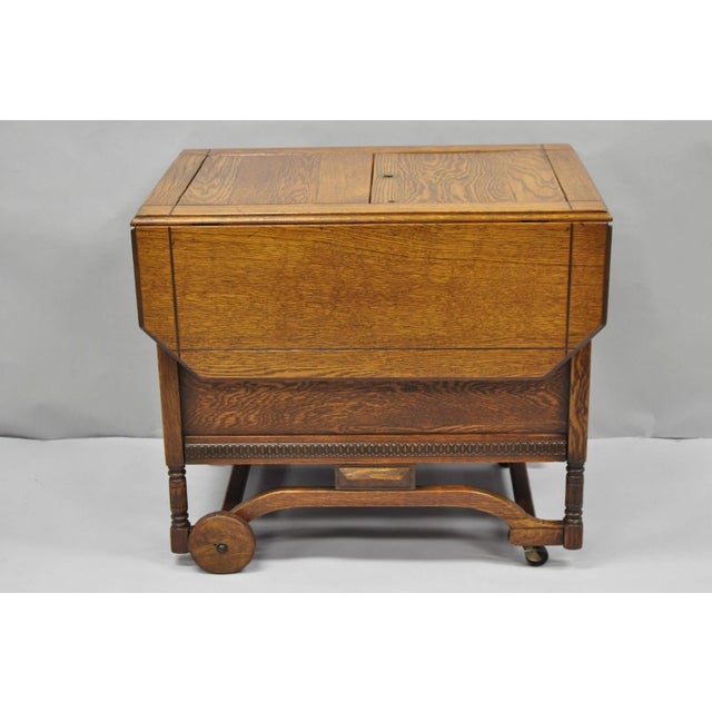 Antique Arts & Crafts Oak Wood Drop Leaf Rolling Bar Cart Liquor Cabinet by Lammert's. Item features double doors, flip...