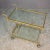 Elegant and functional food trolley Brass and acrylic glass Two crystal shelves The lower shelf features a double bottle...