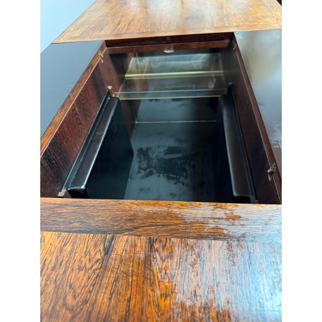An iconic Danish mid-century sliding bar table labeled by E. Pedersen, 1960s. Executed in high quality wood, the elongated...