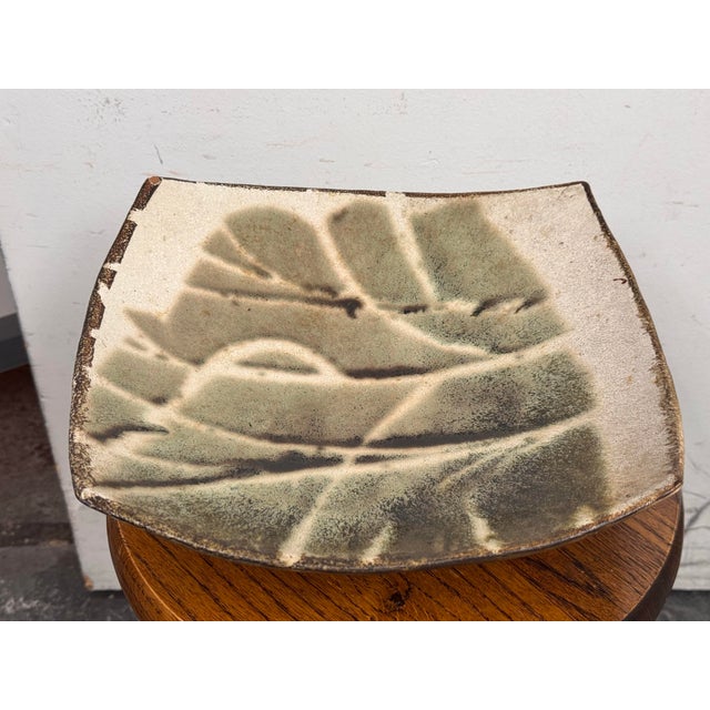 Design Plus Gallery presents a signed E. Prieto Organic Modern Ceramic Footed Bowl. The bowl has a gently concave square...