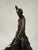 Dynamic and expressive bronze sculpture capturing a cowboy riding a bucking horse, rendered in a distinctly modern,...